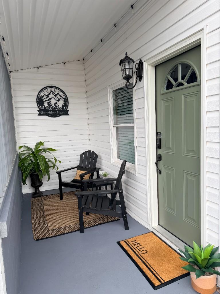 Blue Ridge Haven — Daytime front porch with Adirondack chairs, Blueridge Haven sign, and digital entry