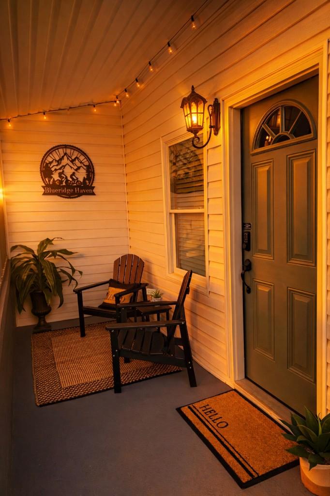 Blue Ridge Haven front porch with seating and string lights at dusk