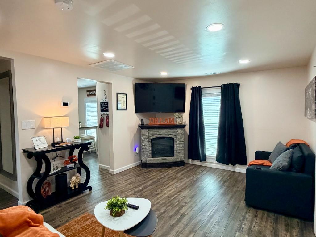 Fiddlers Roost living room with stone fireplace, TV, and seating