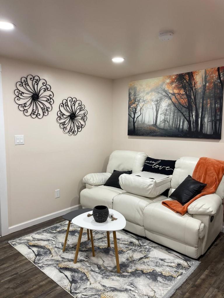 Fiddlers Roost living area with fireplace, console, and adjoining kitchen view