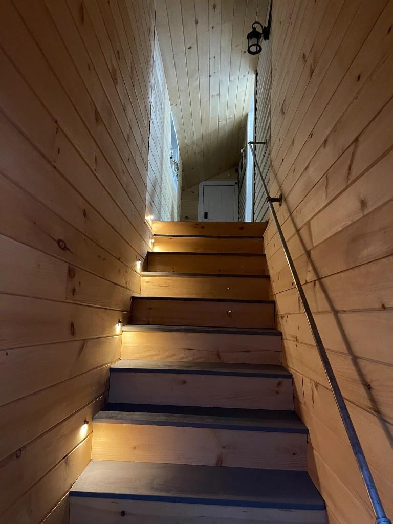 Fiddlers Roost interior stairway with wood walls and accent lighting