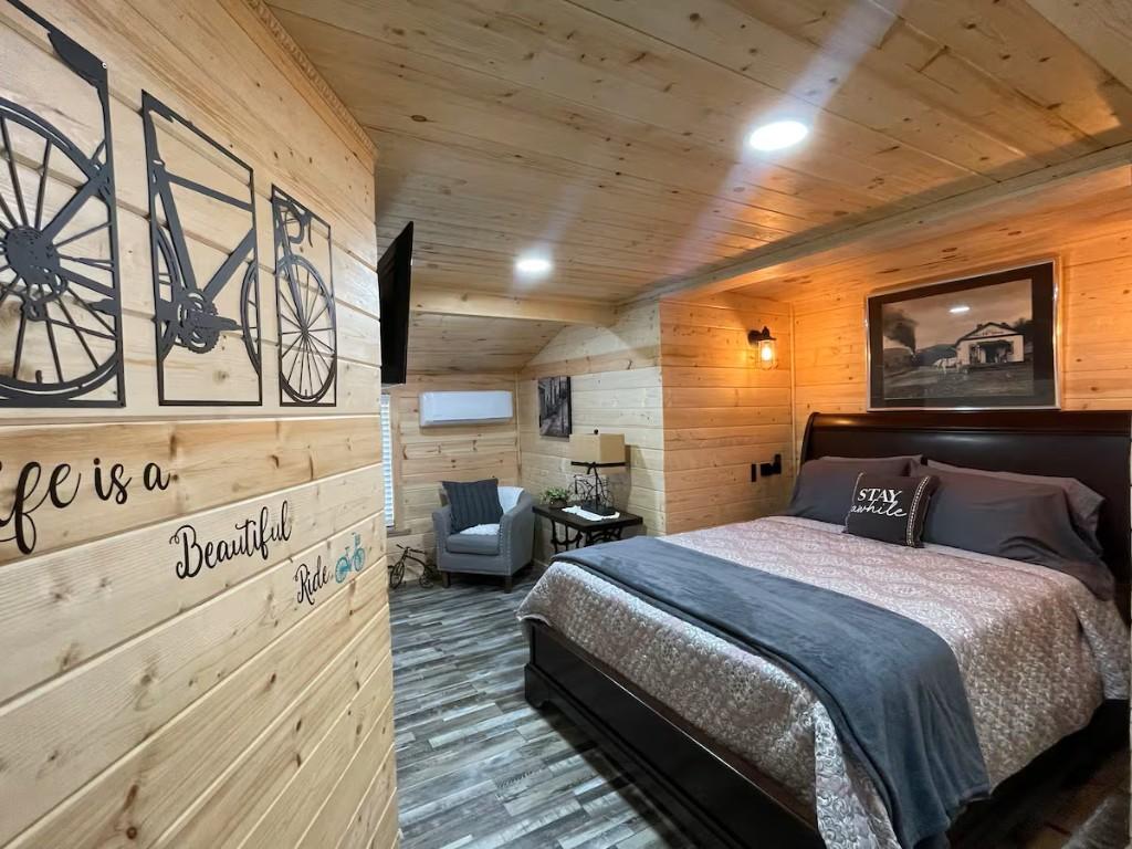 New River Hideaway bedroom with wood-paneled walls and queen bed