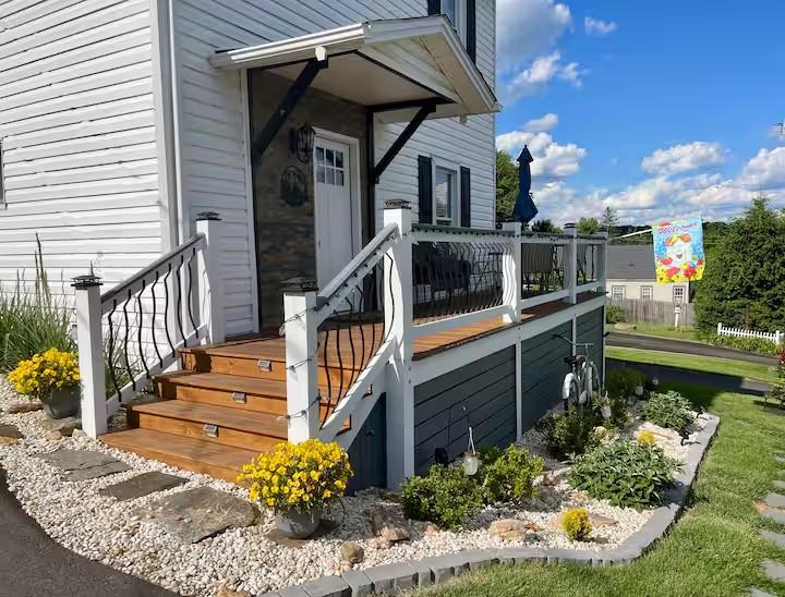 New River Hideaway elevated deck, stairs, and entry with string lights