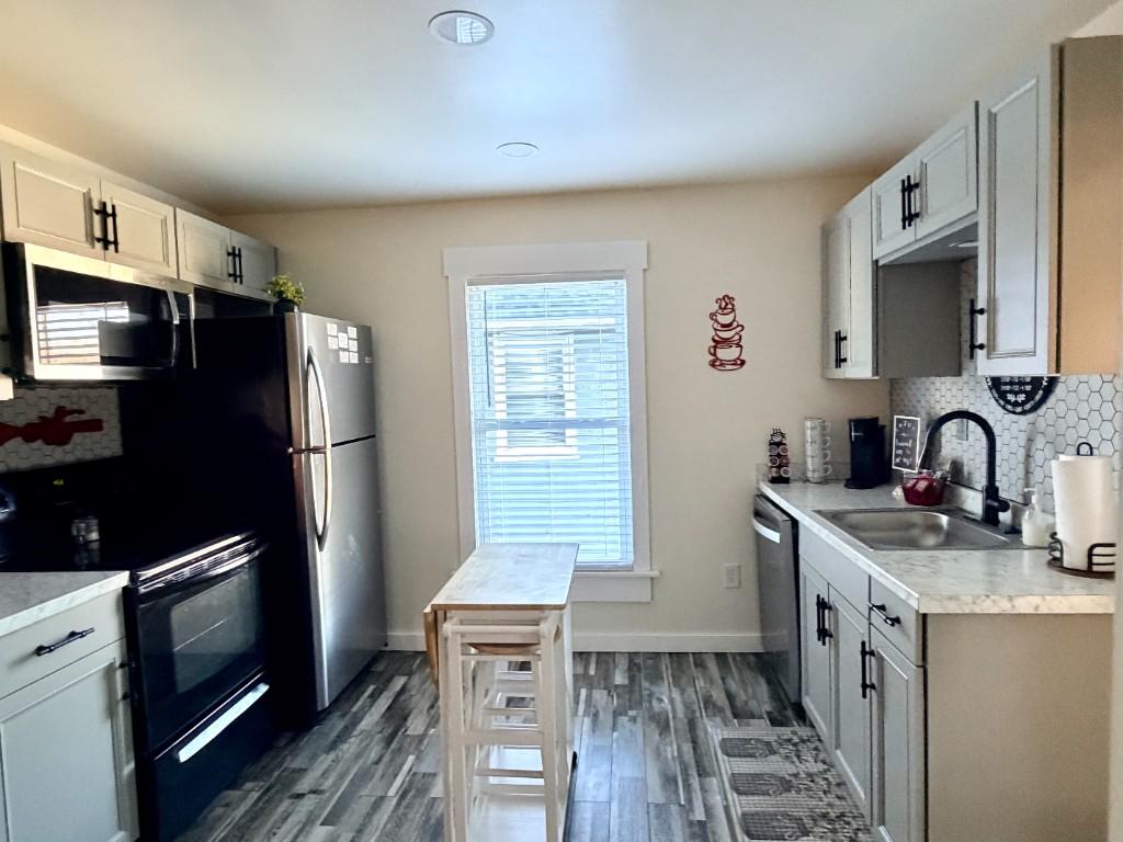New River Hideaway kitchen with grey cabinets and stainless appliances