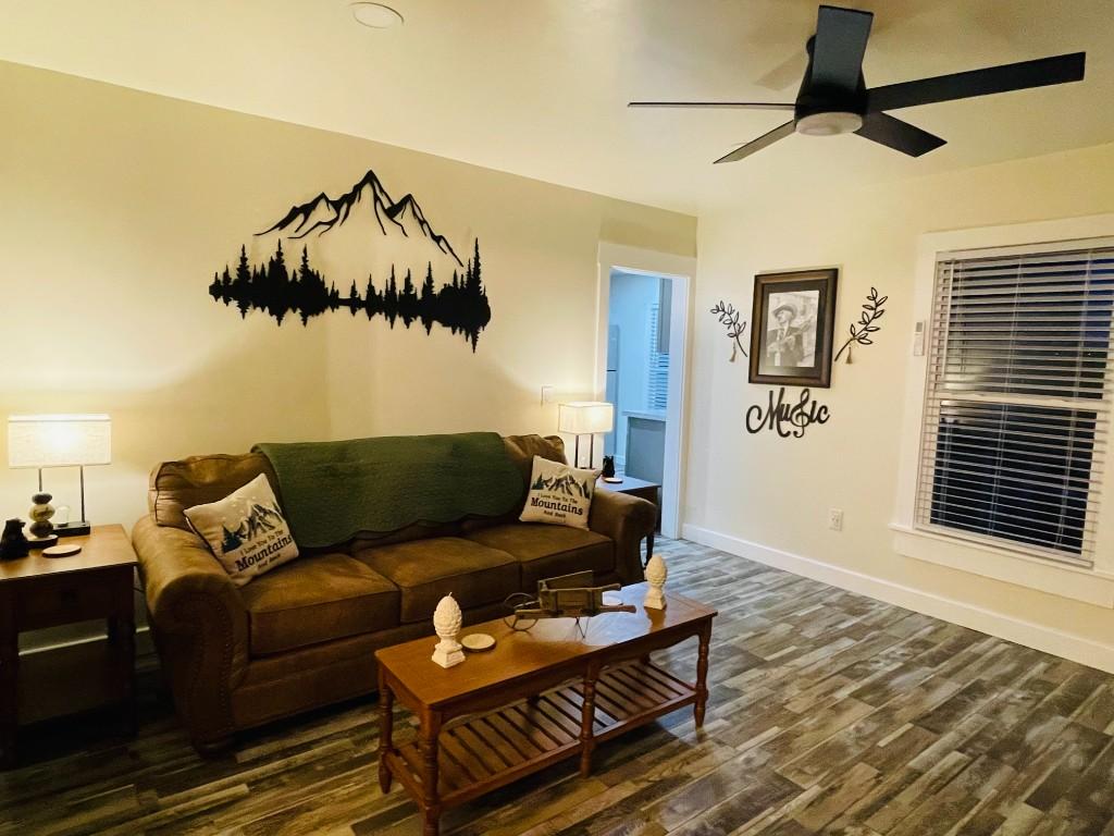 New River Hideaway living room with leather sofa and mountain wall art